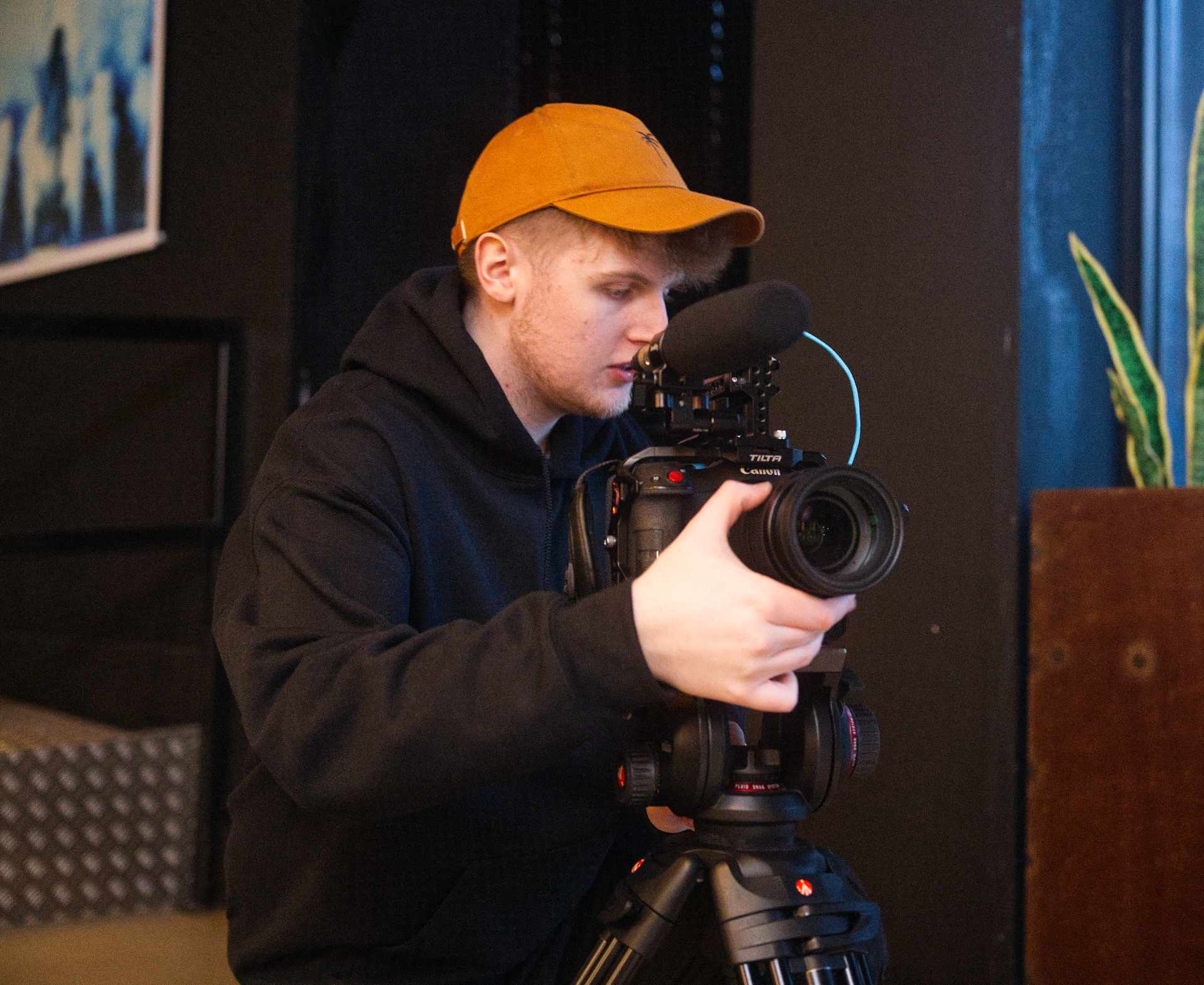 Josiah taking pictures with a professional camera for a charity client